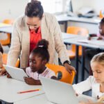 Tutor and school children in a classroom